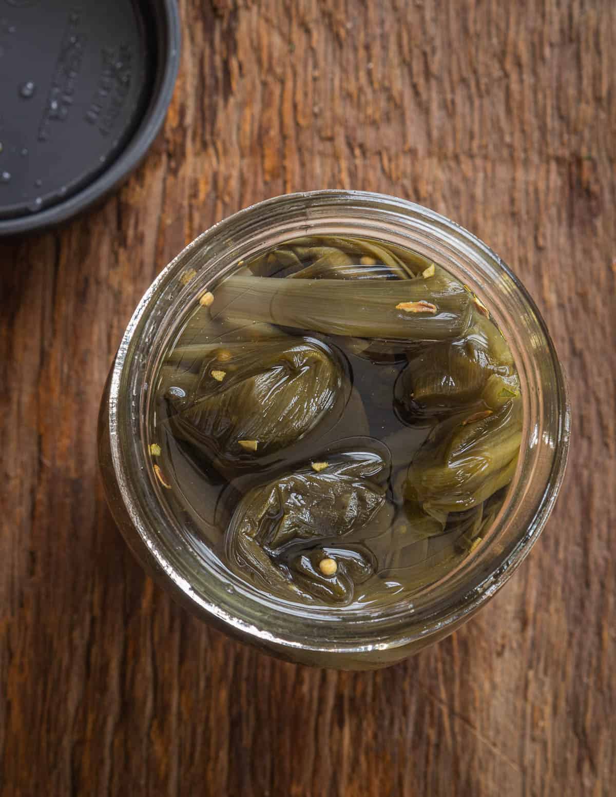 a jar of pickled ramp or wild leek leaves. 