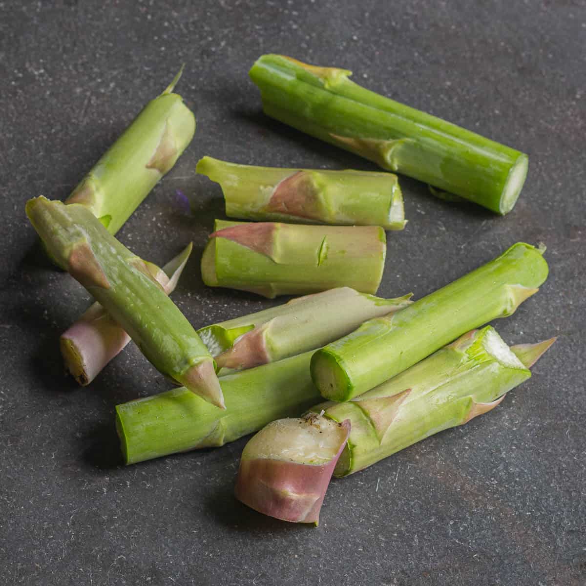 Cut woody ends of asparagus on a piece of slate.