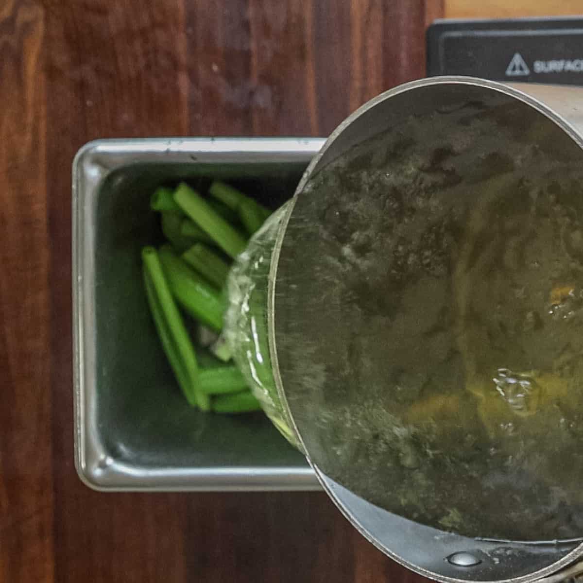 pouring hot sugar syrup over a pan of angelica stems. 