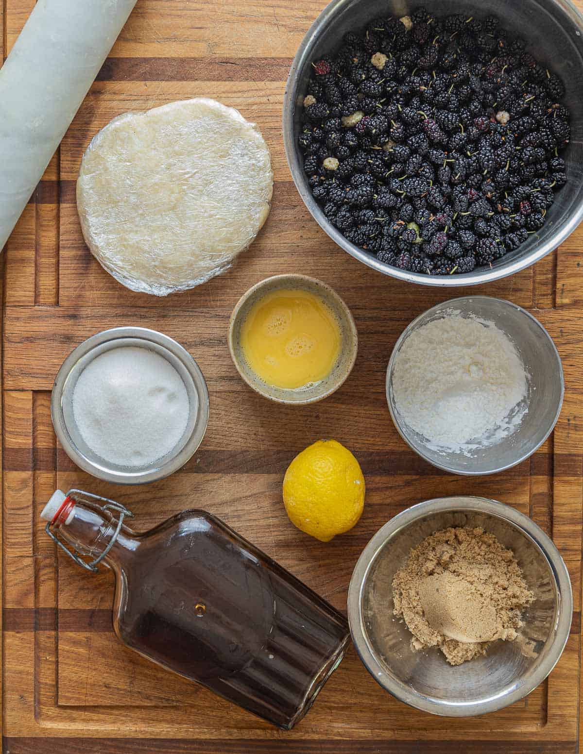 Mulberry pie ingredients: egg wash, white sugar, brown sugar, vanilla extract, a lemon, and cornstarch. 