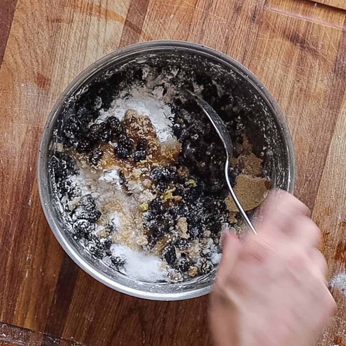 Mixing together ingredients for mulberry pie. 