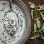 A pan of sorrel sauce next to wild sorrel.