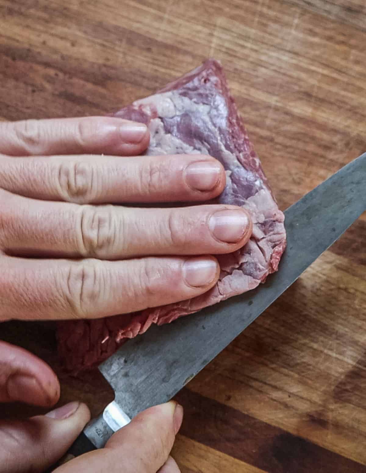 Removing the silverskin from the bavette steak.