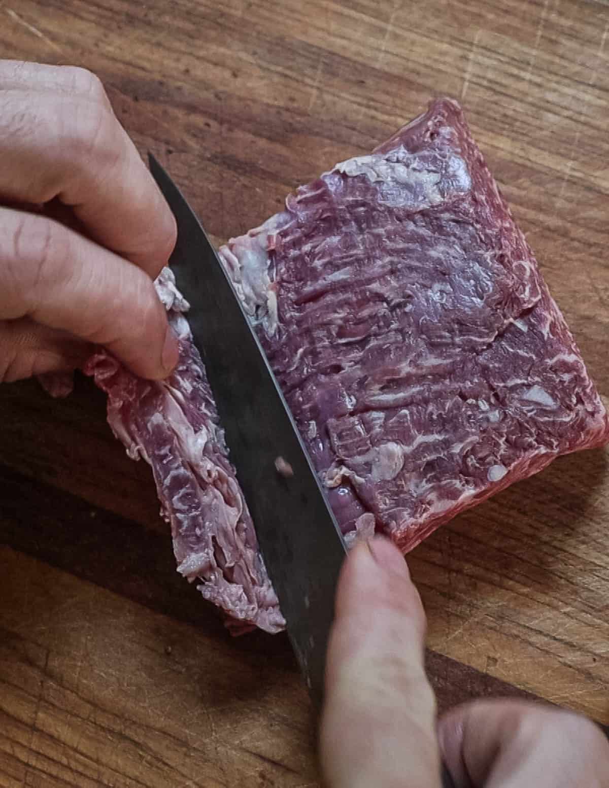 Removing silver skin from the bavette steak.