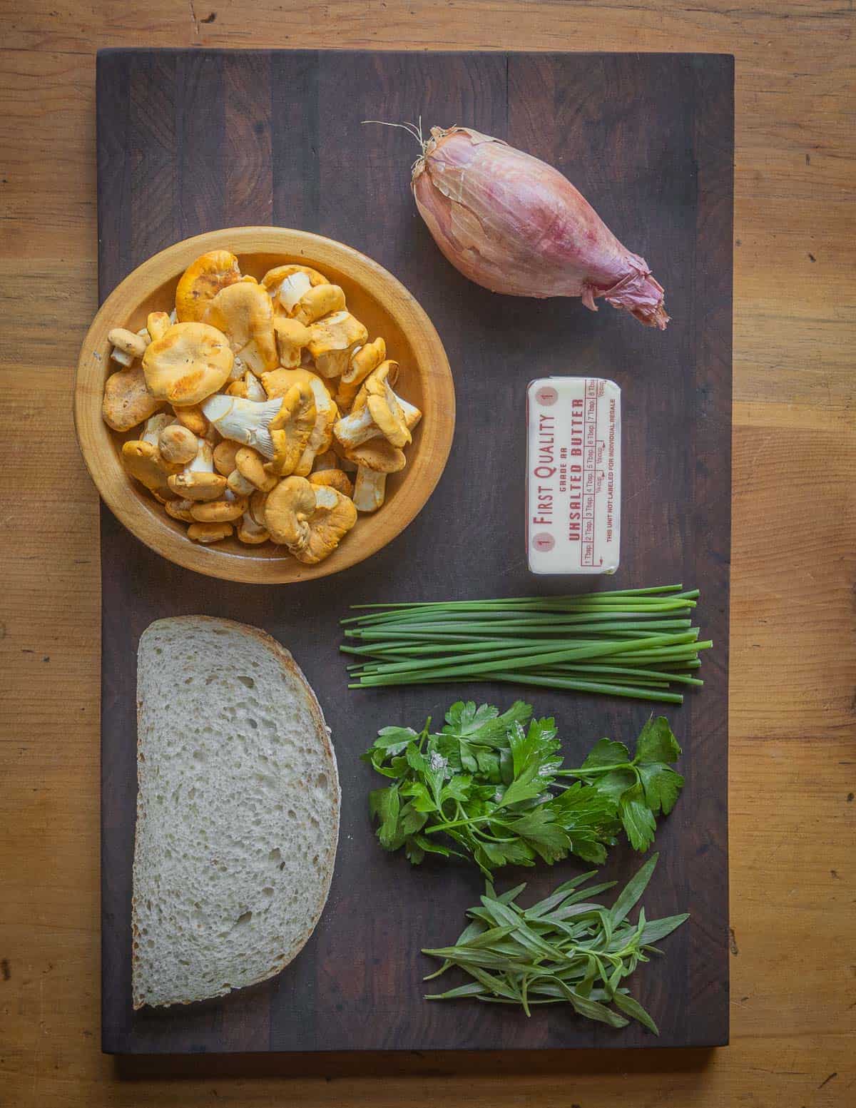 Ingredients for chanterelle toast: mushrooms, shallots, butter and herbs. 