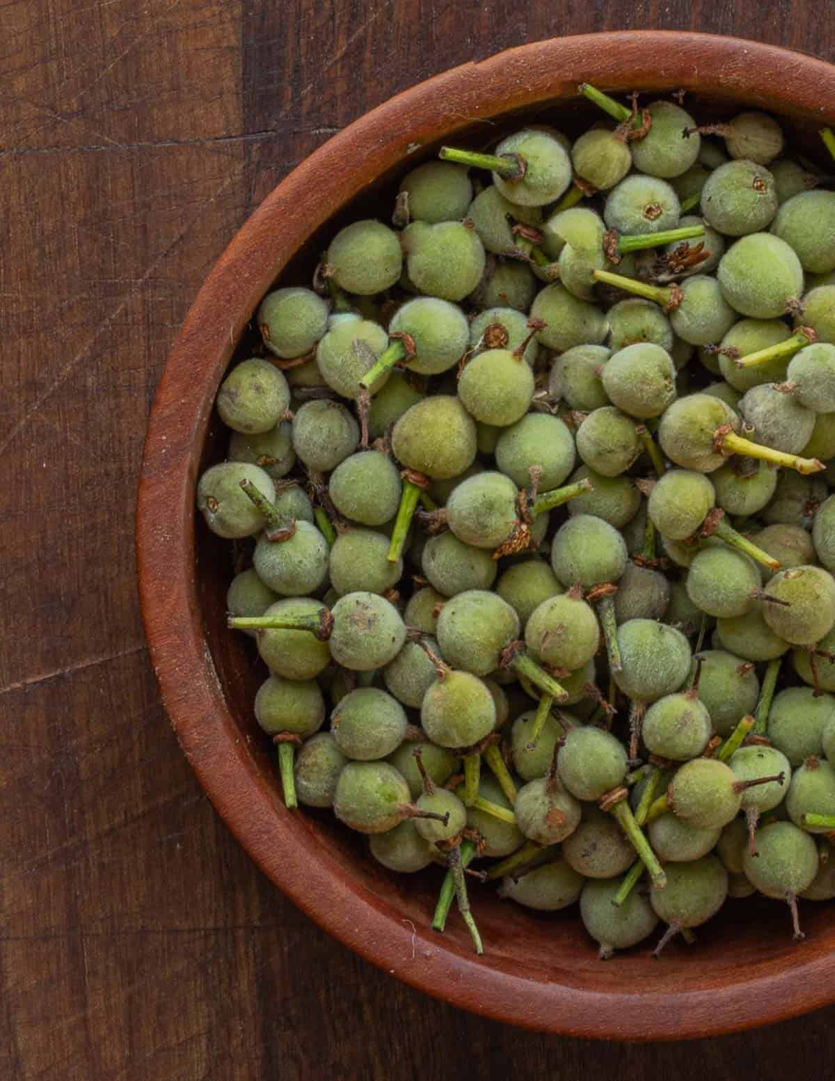 Green linden seeds in a wooden bowl. 