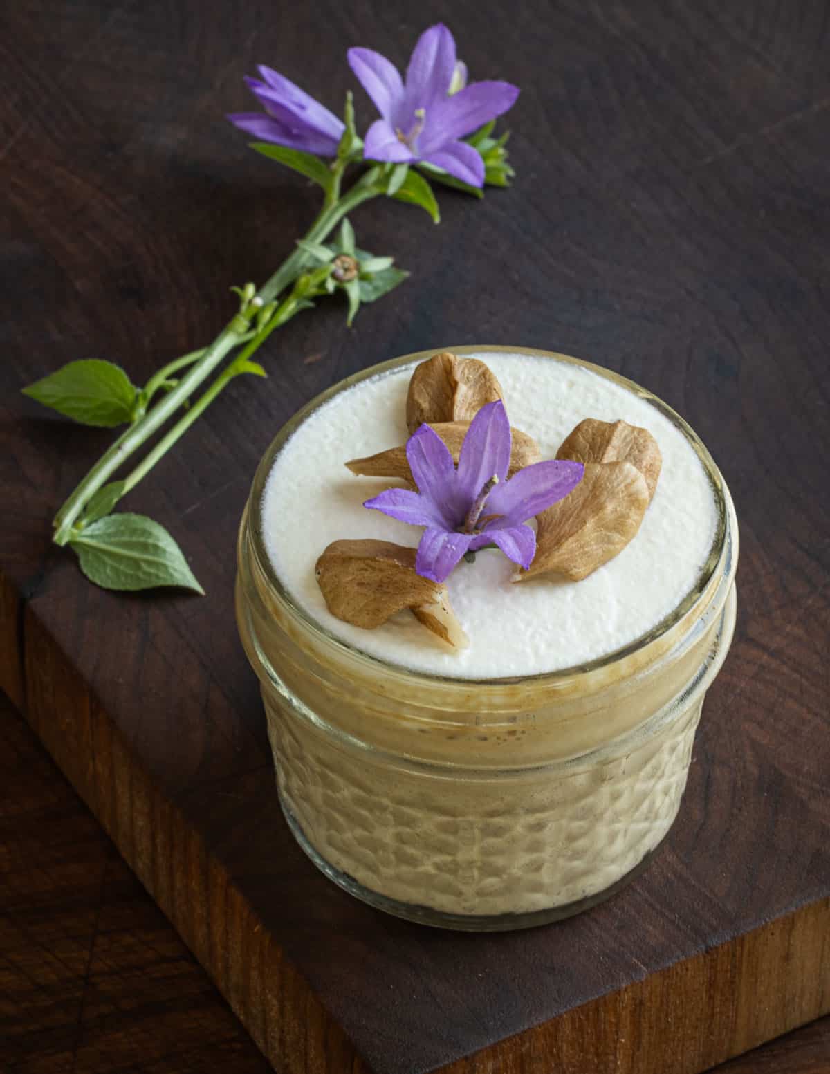 Linden seed custard garnished with fresh butternuts or white walnuts, whipped cream and bellflowers. 