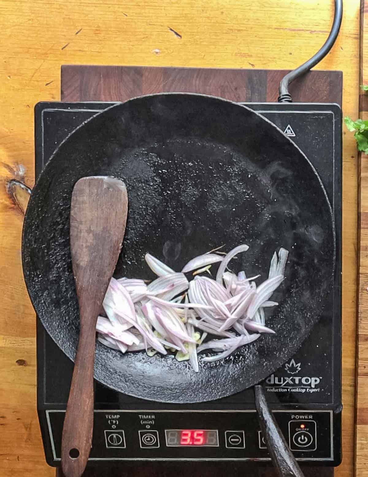 Cooking garlic and shallots in a pan.