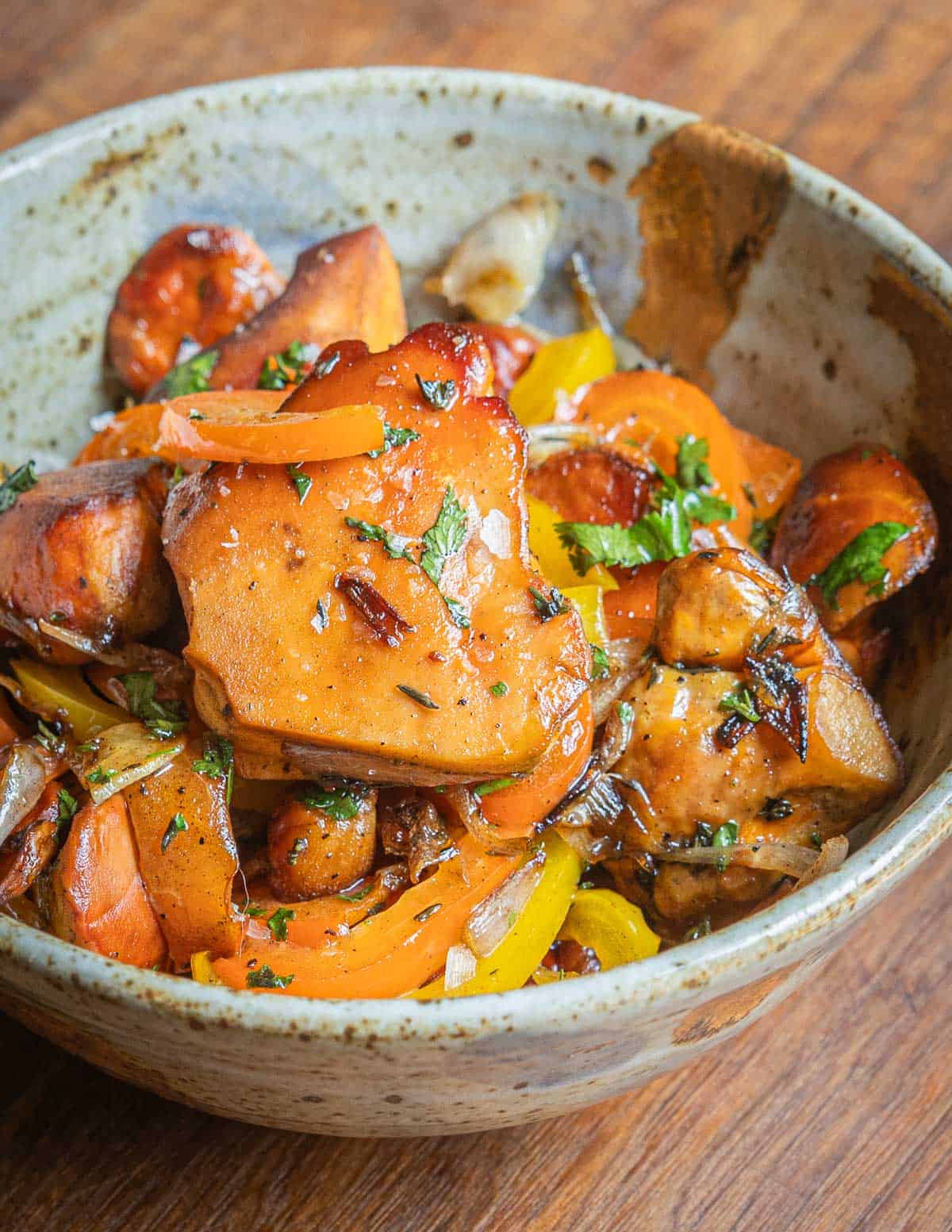 Sauteed chicken of the woods mushrooms in a bowl with onions and bell peppers.