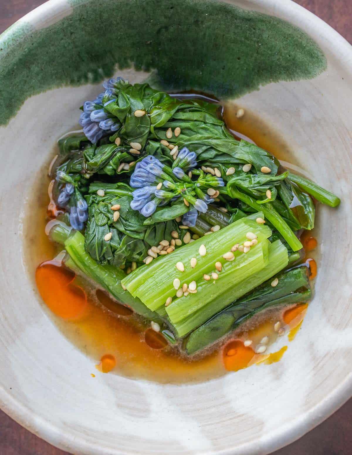 Cooked Virginia bluebells in a bowl with broth. 