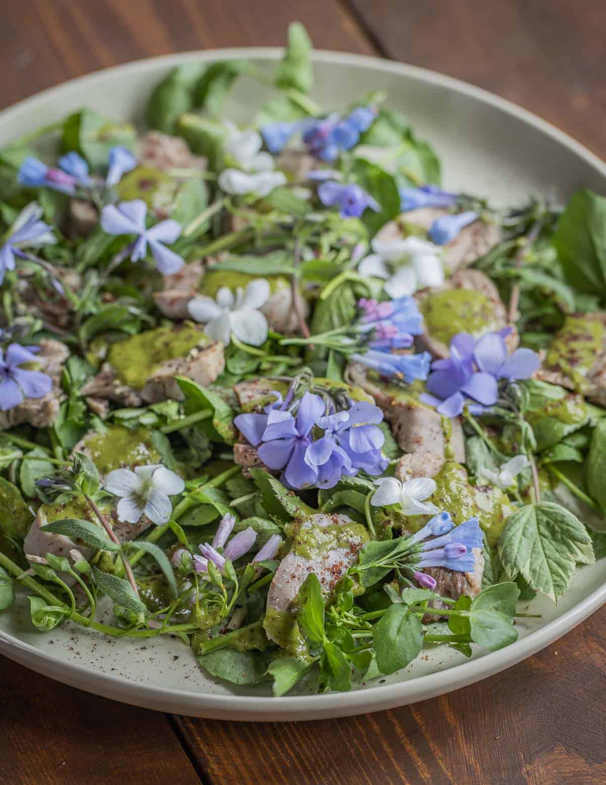 A salad of goat tongue garnished with wild phlox and bluebell flowers. 