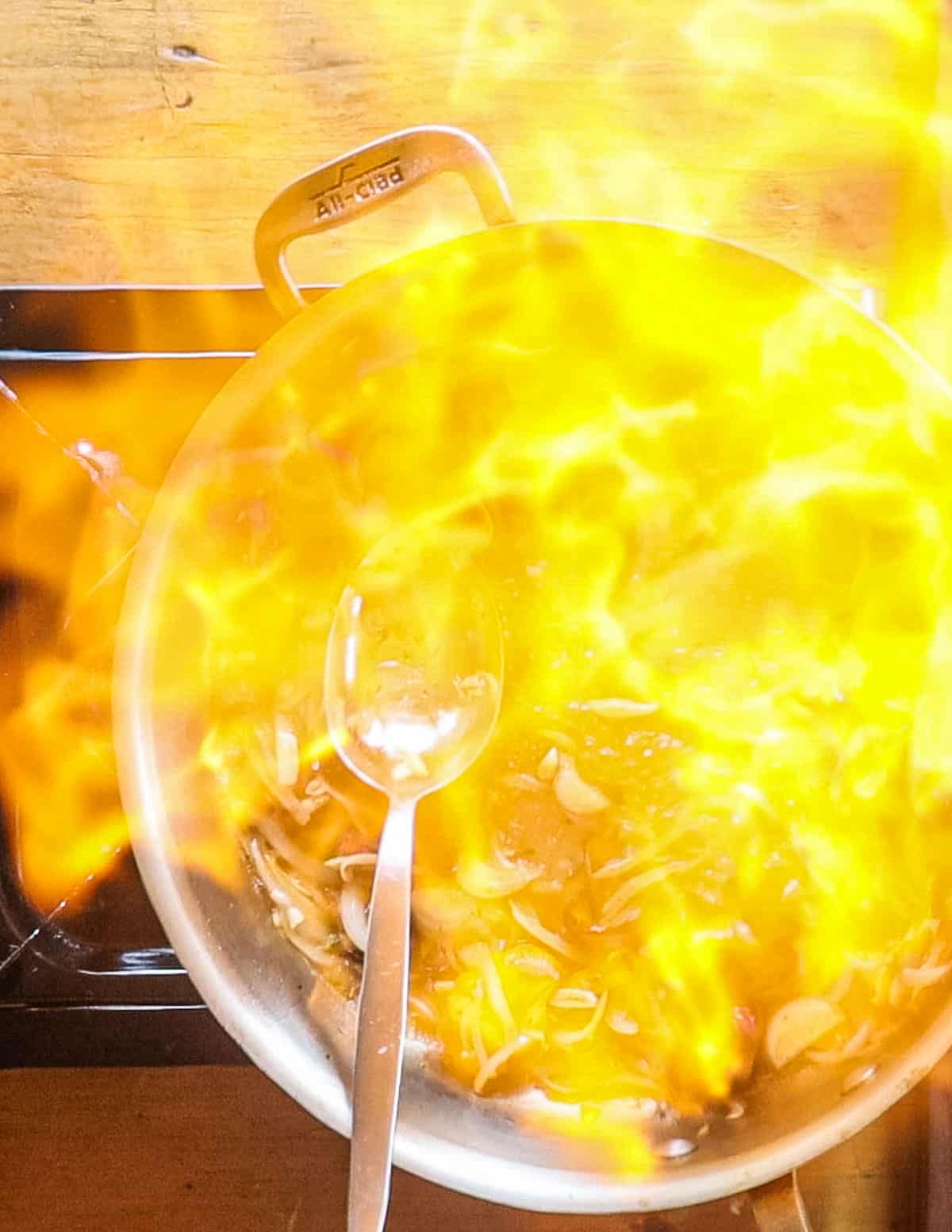 Igniting brandy in a pan. 