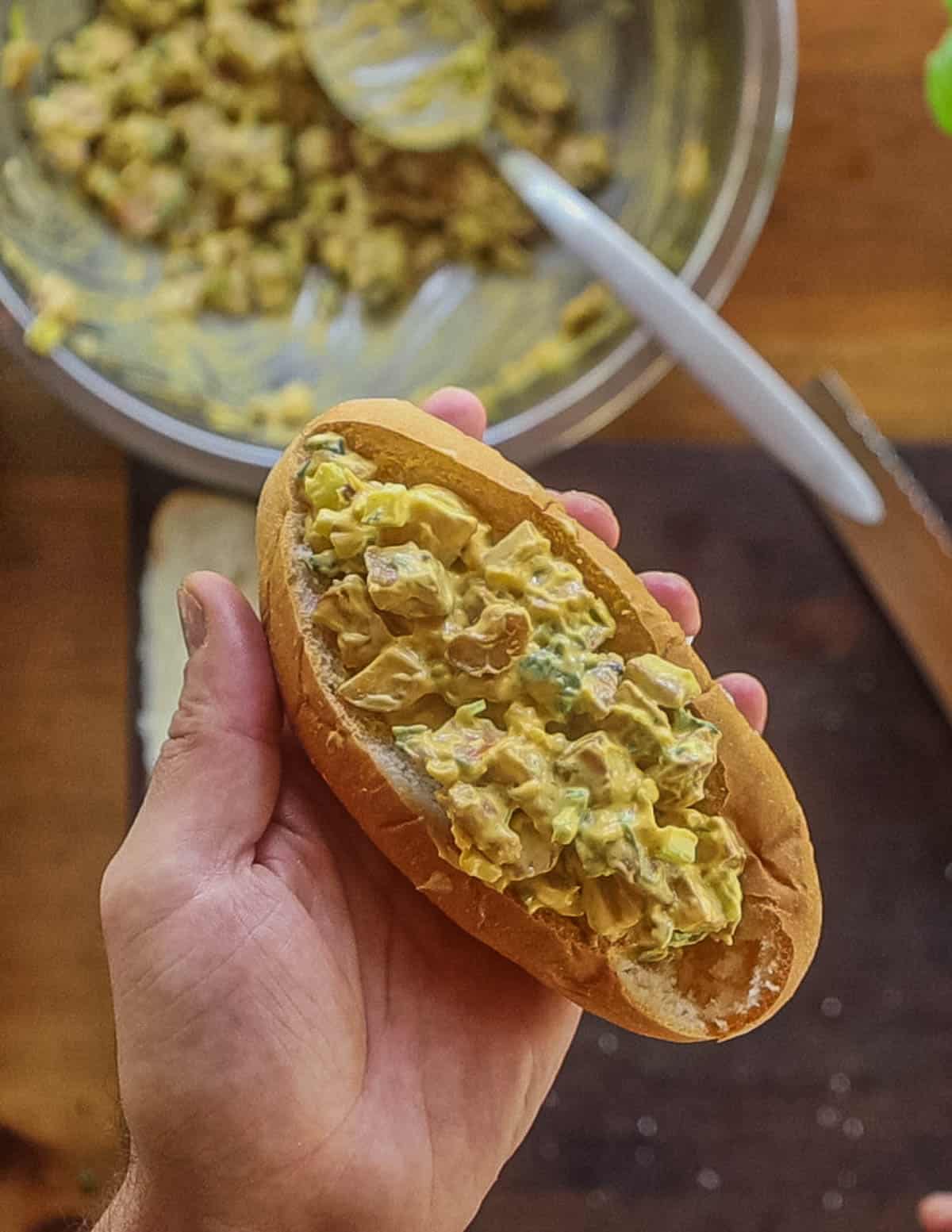 A finished lobster mushroom roll in a bun. 