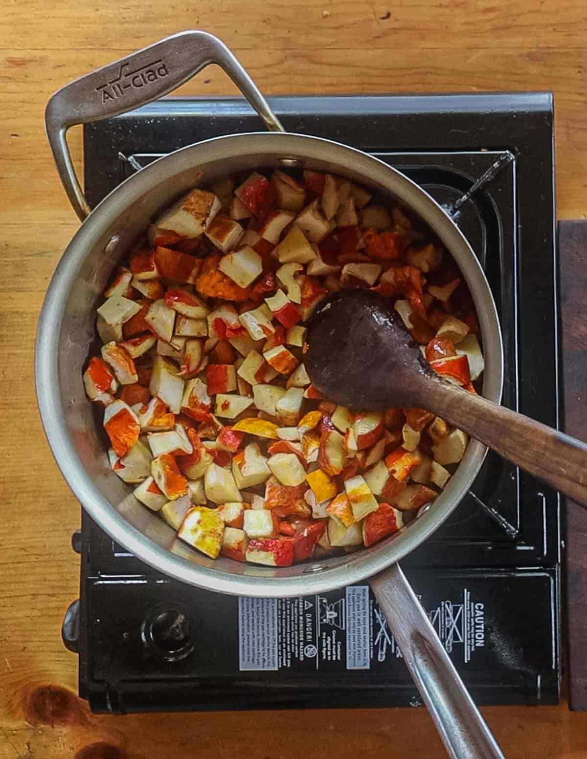 Cooking lobster mushrooms in oil in a pot. 