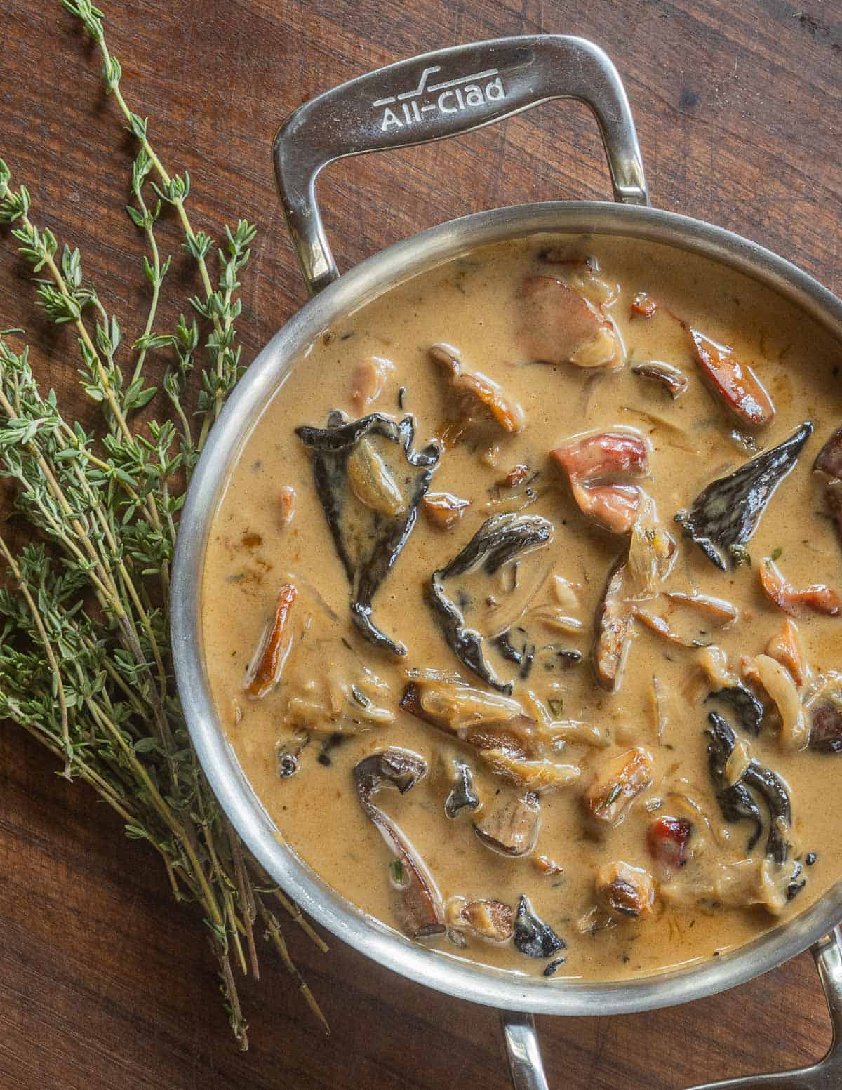 A small pan of forestiere sauce made with wild mushrooms in an all clad pot. 