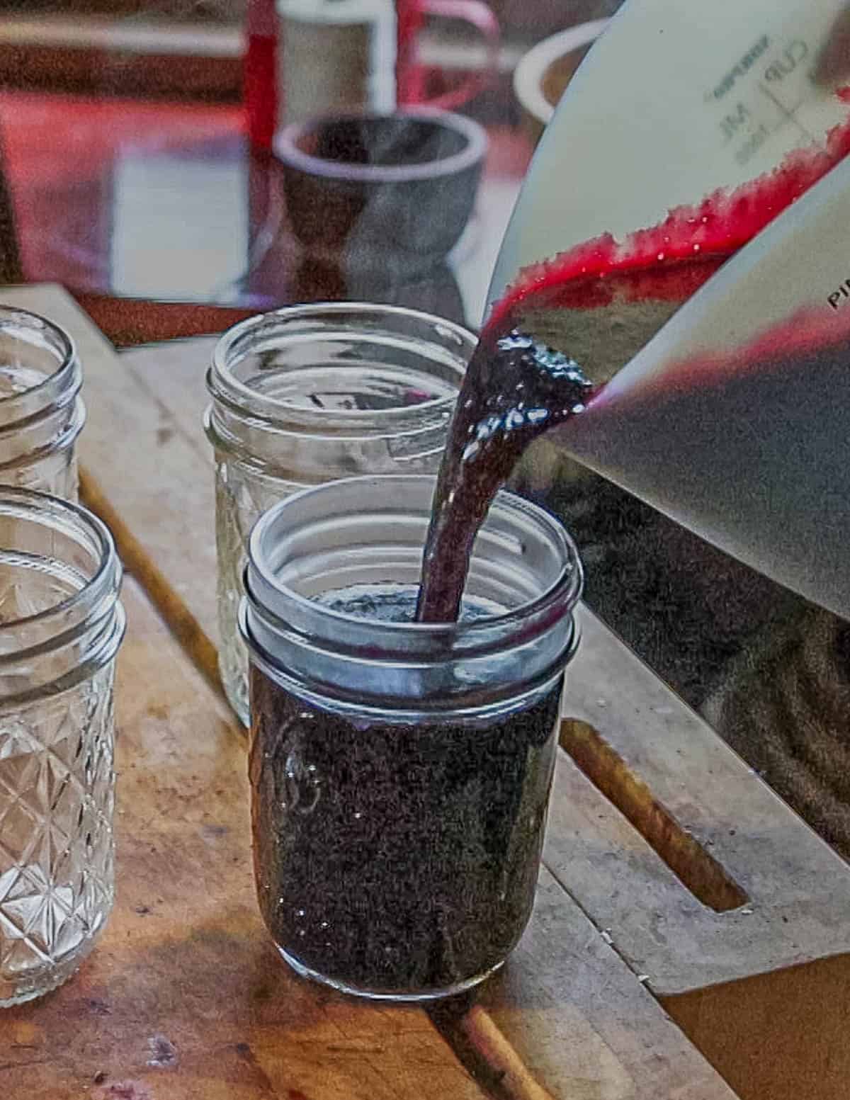 Pouring preserves into canning jars. 