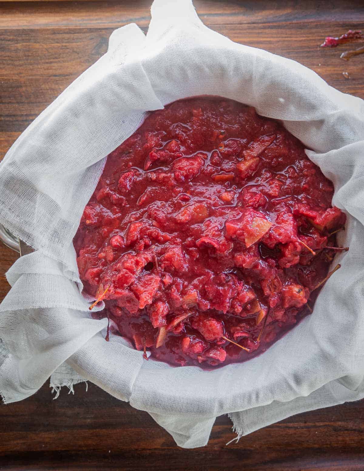 Draining crab apple juice through cheesecloth. 