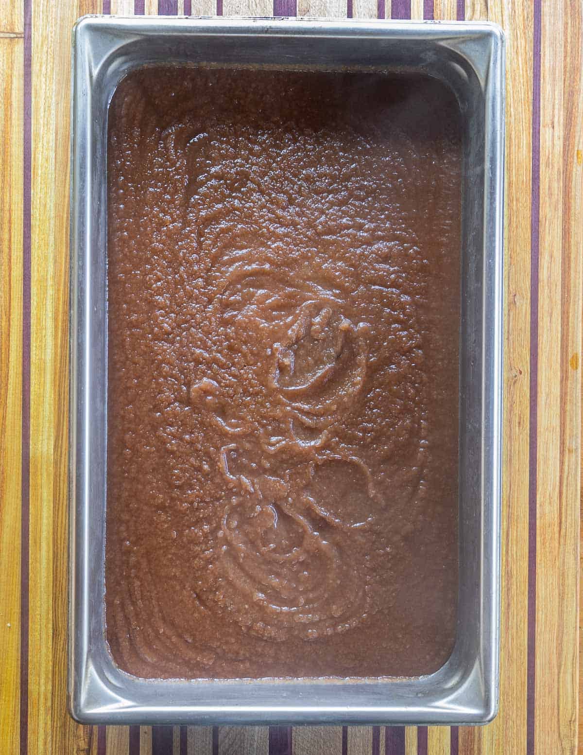 A tray of brown apple butter that's baked in the oven. 