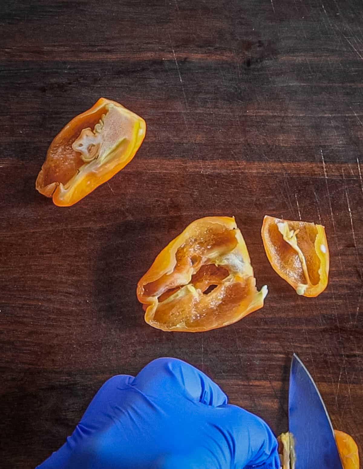 Removing seeds from habanero hot peppers. 