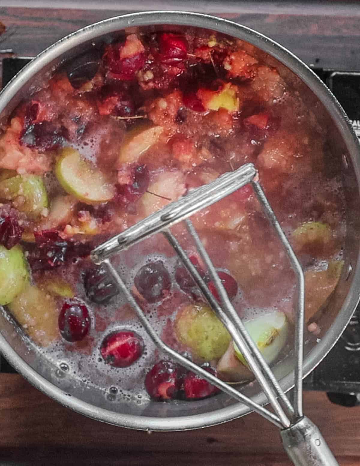 Mashing crab apples and regular apples. 