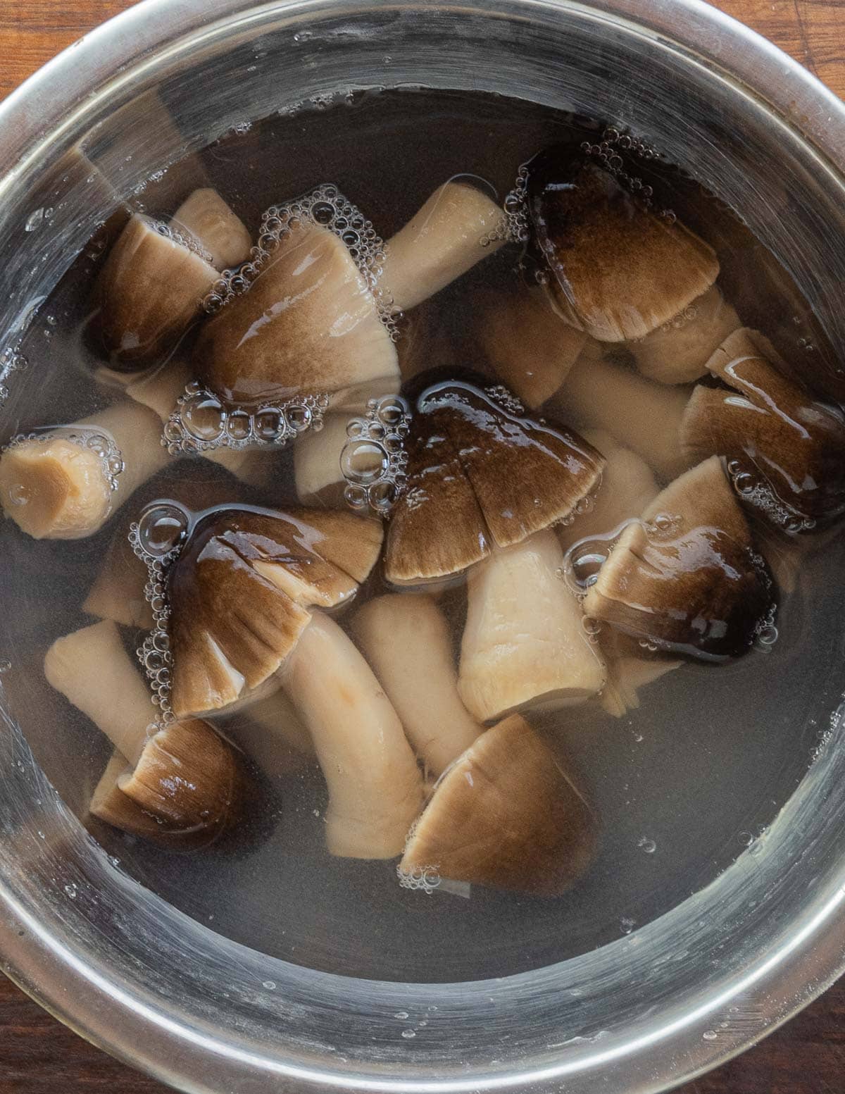 A close up image of paddy straw mushrooms in a bowl. 