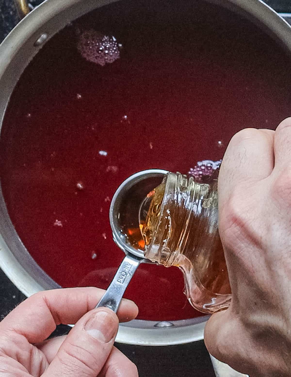 Adding maple syrup to crab apple cider. 