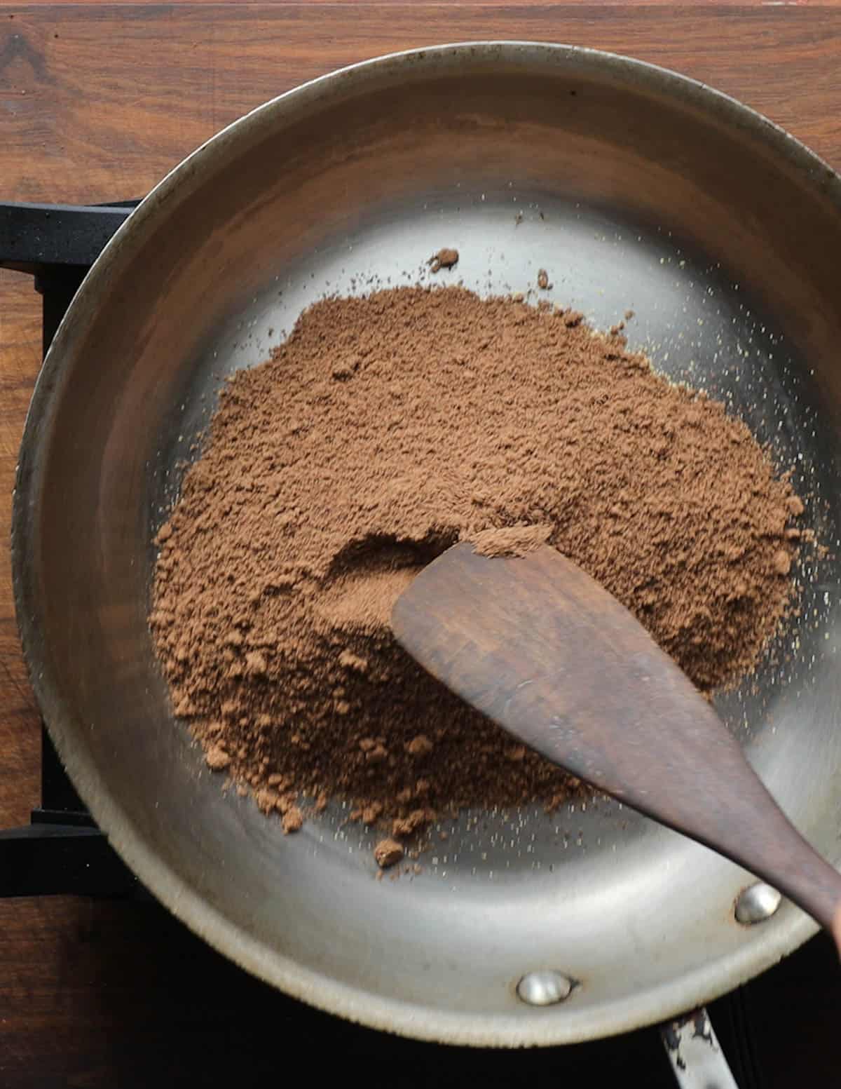 Toasting acorn meal and cornmeal in a saute pan. 