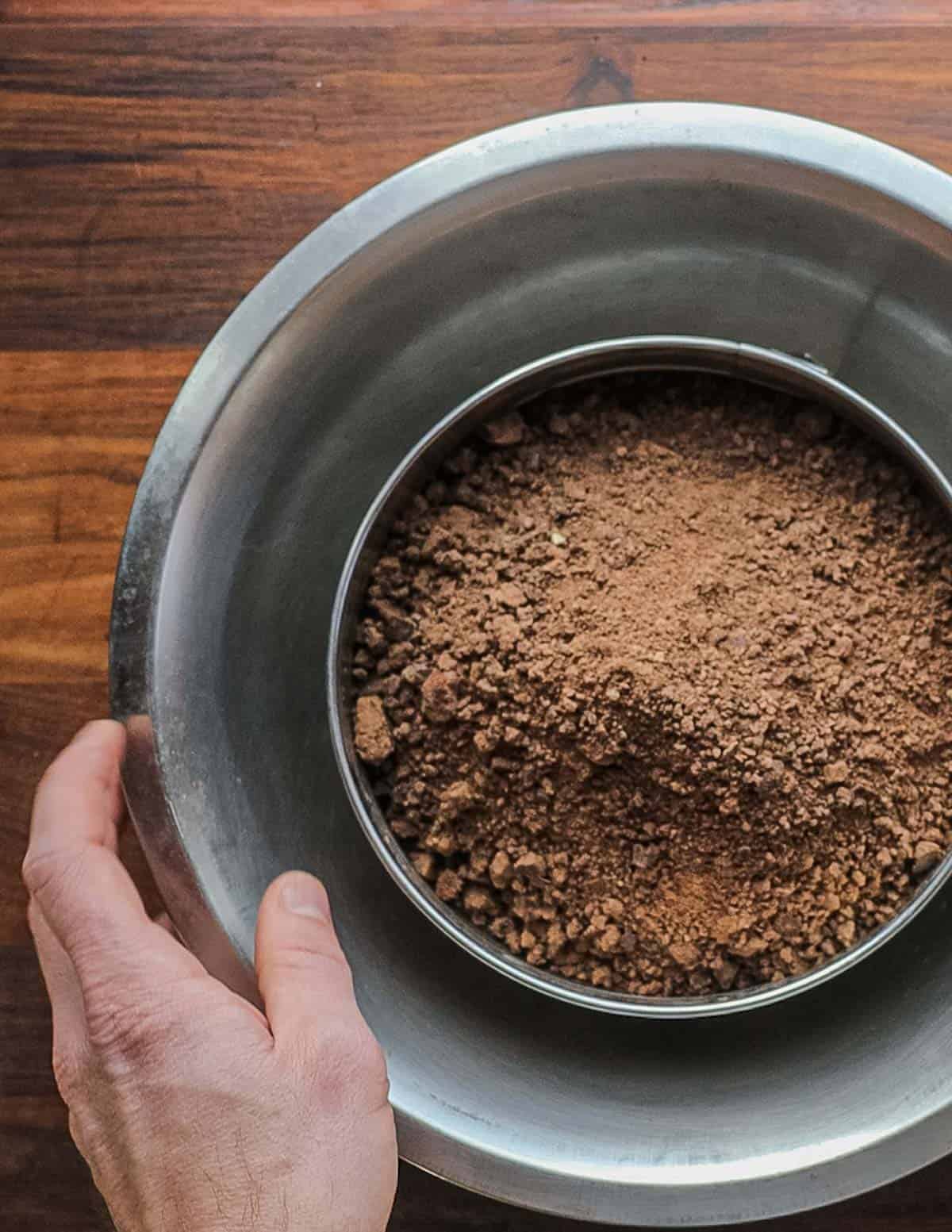 Sifting cold leached acorn flour through a tamis sieve. 