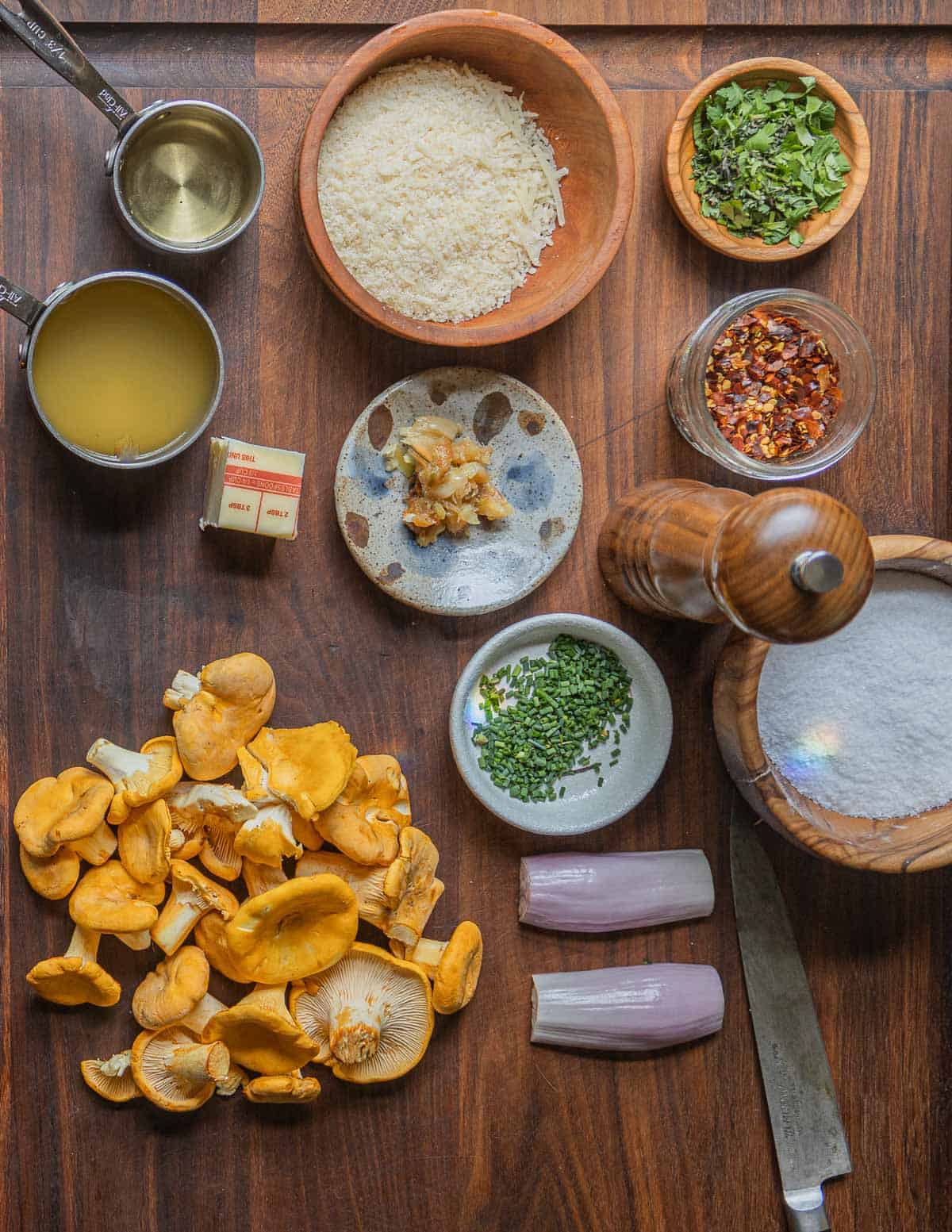 Ingredients for chanterelle mushroom pasta: chanterelles, shallots, roasted garlic, butter, wine, chicken stock, herbs, salt, and crushed red pepper. 