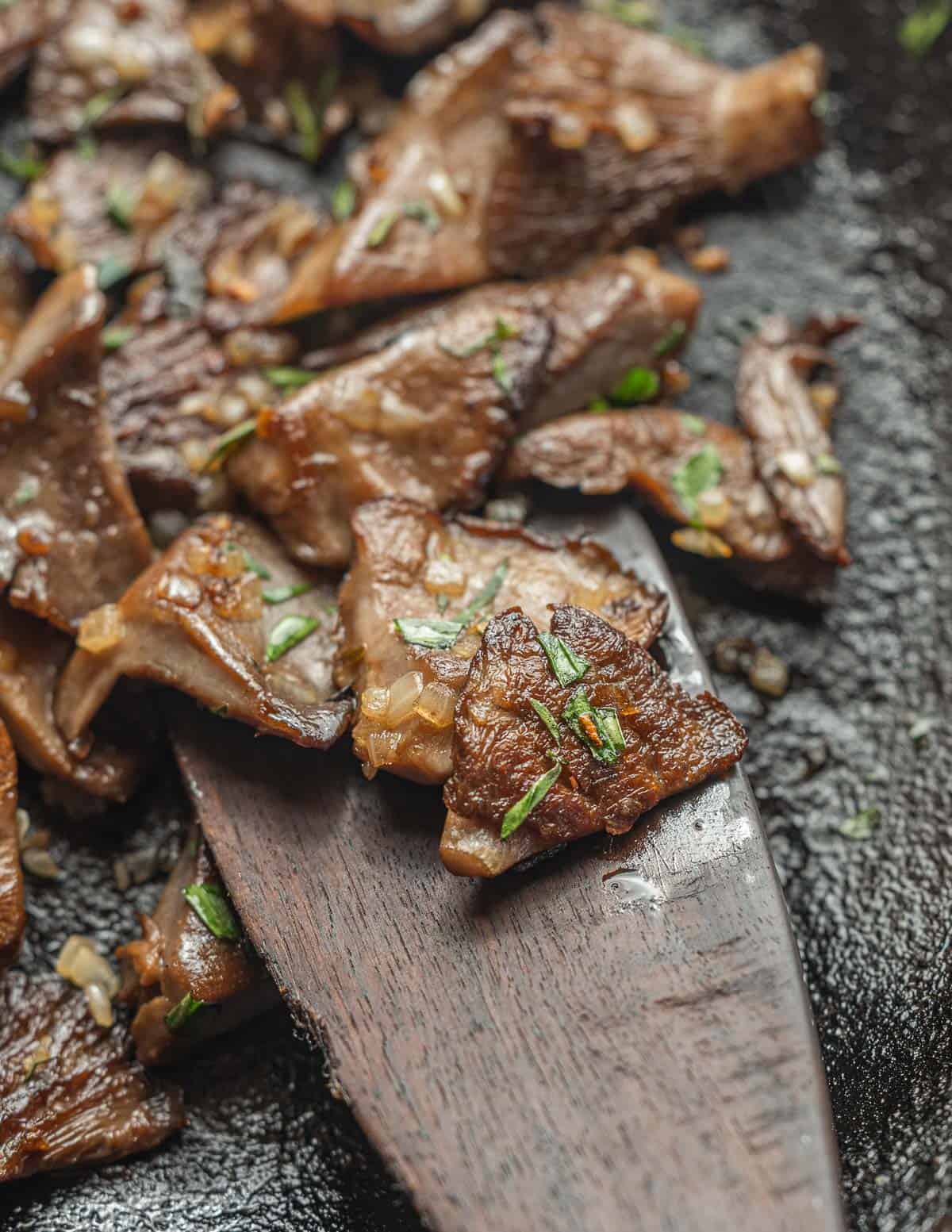 Close up picture of field blewit mushrooms cooked with shallots and tarragon. 