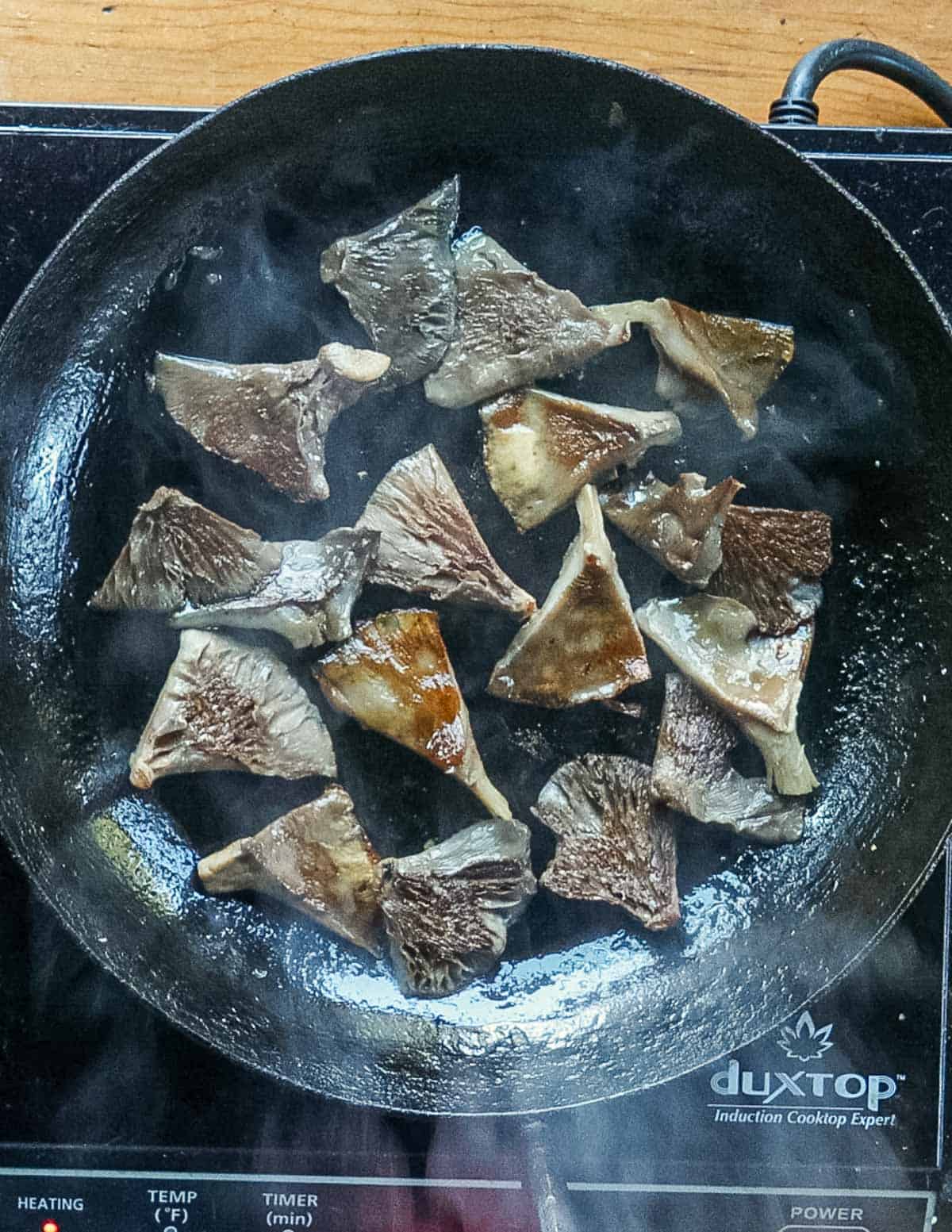 A pan of sauteed, golden brown mushrooms. 
