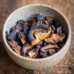 Shiitake mushroom jerky in a ceramic cup.