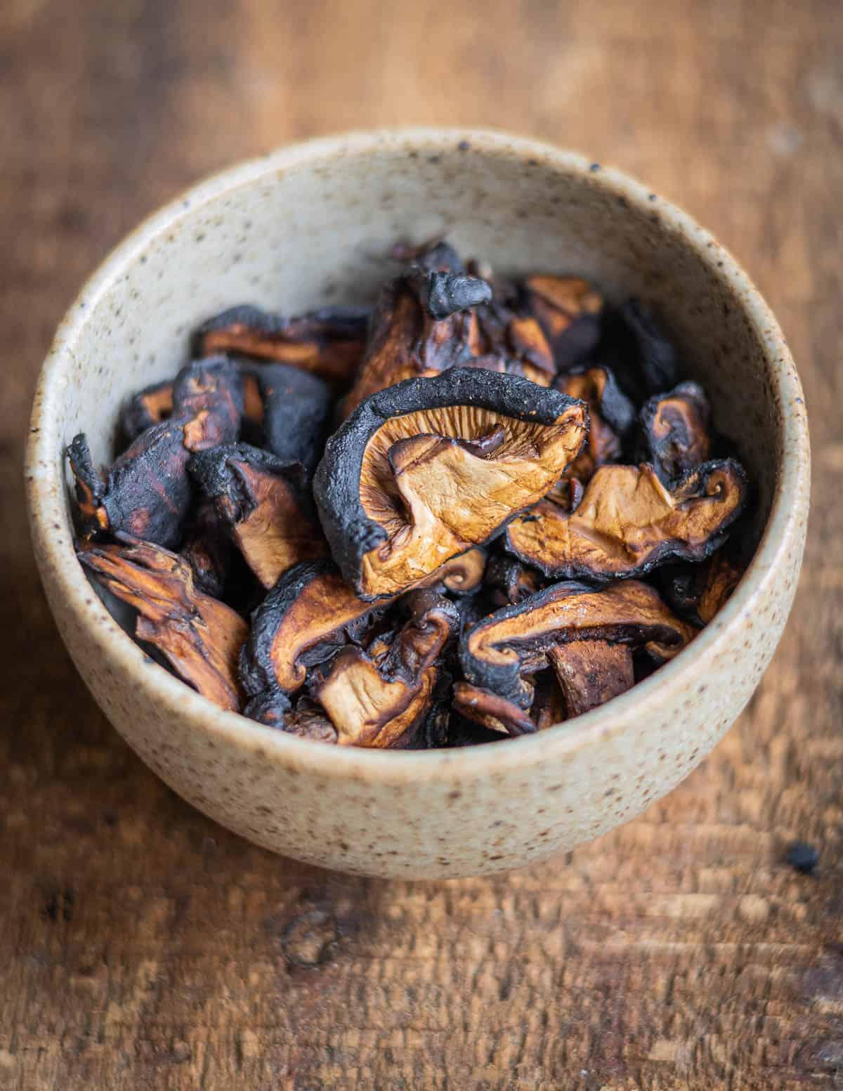 Shiitake  mushroom jerky in a ceramic cup. 