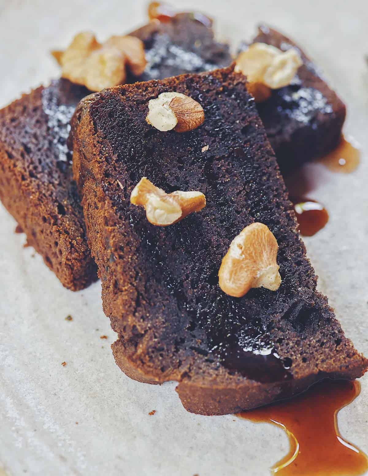 A slice of nannyberry bread with black walnuts drizzled with pine cone syrup. 