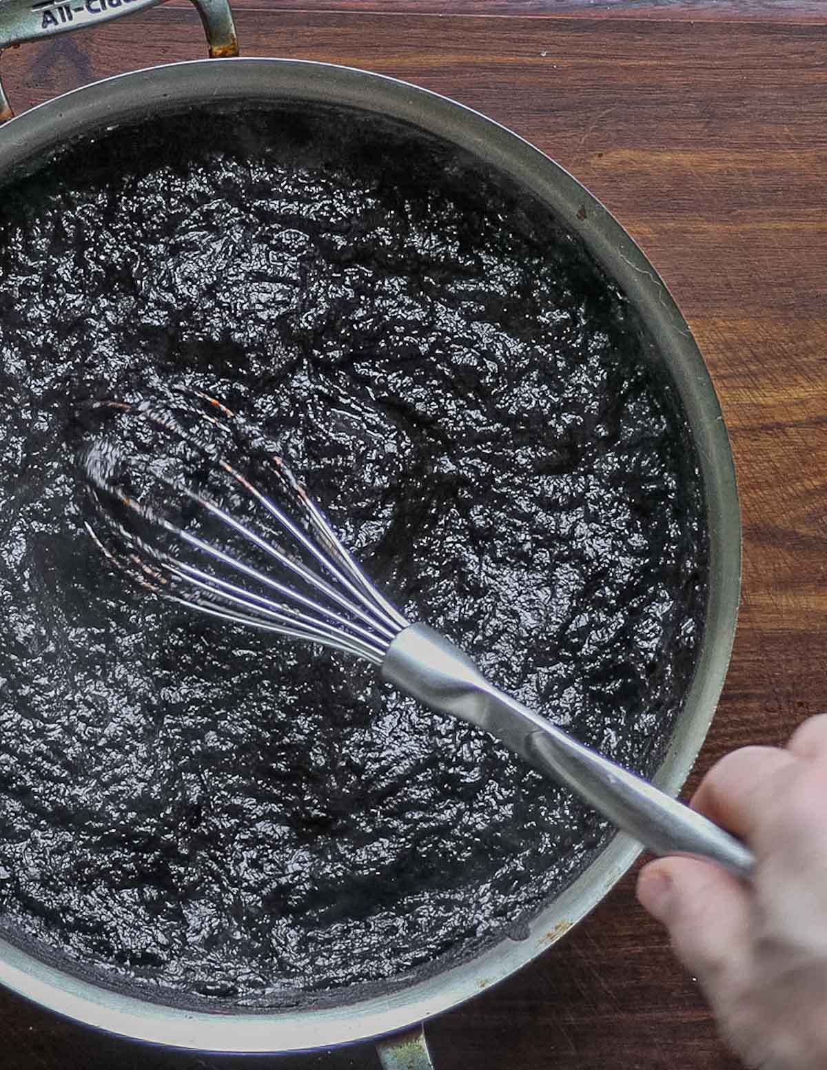 Stirring nannyberry puree with a whisk. 