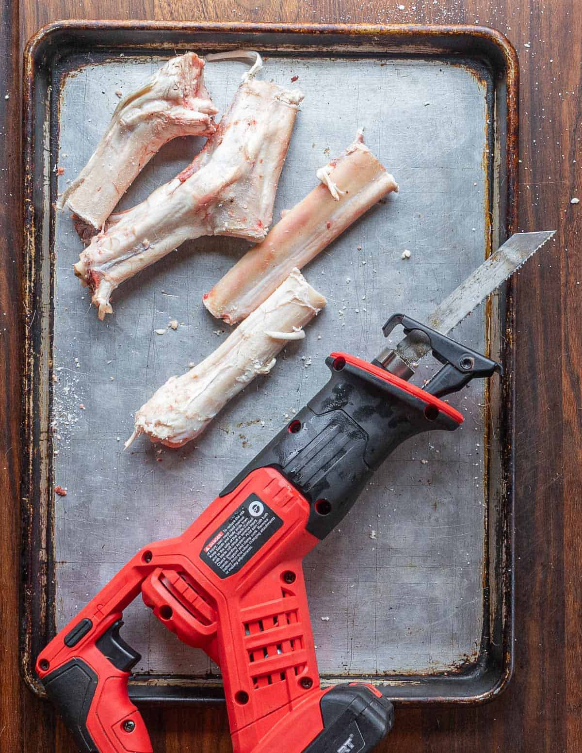 Cutting venison leg bones into pieces with a sawzall or reciprocating saw. 