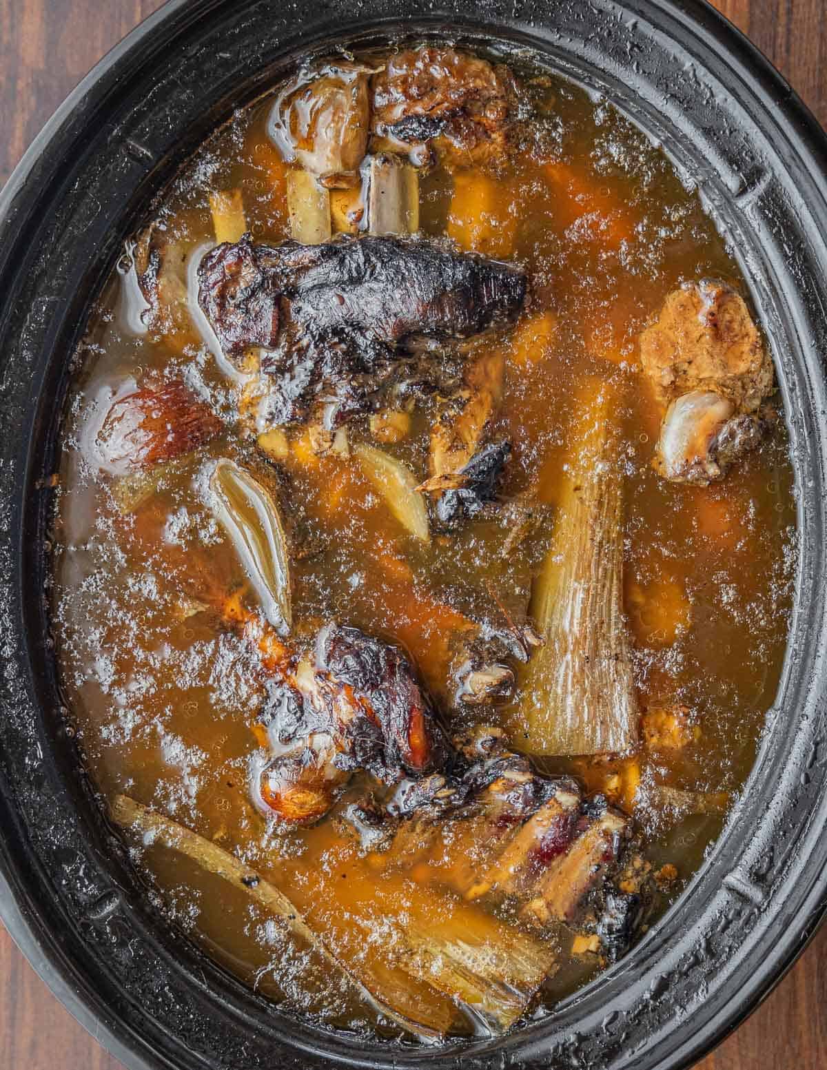 A slow cooker full of venison bones and meat for making stock. 