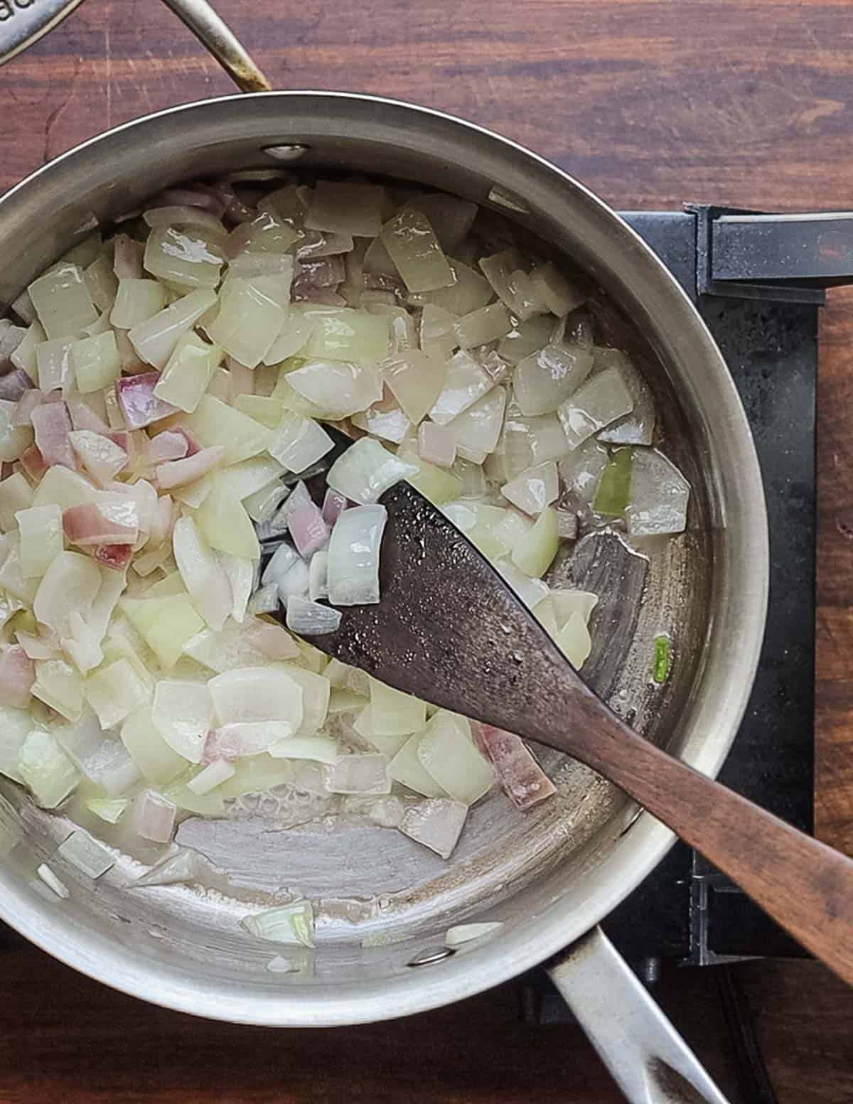 Cooking onions in a soup pot with butter.