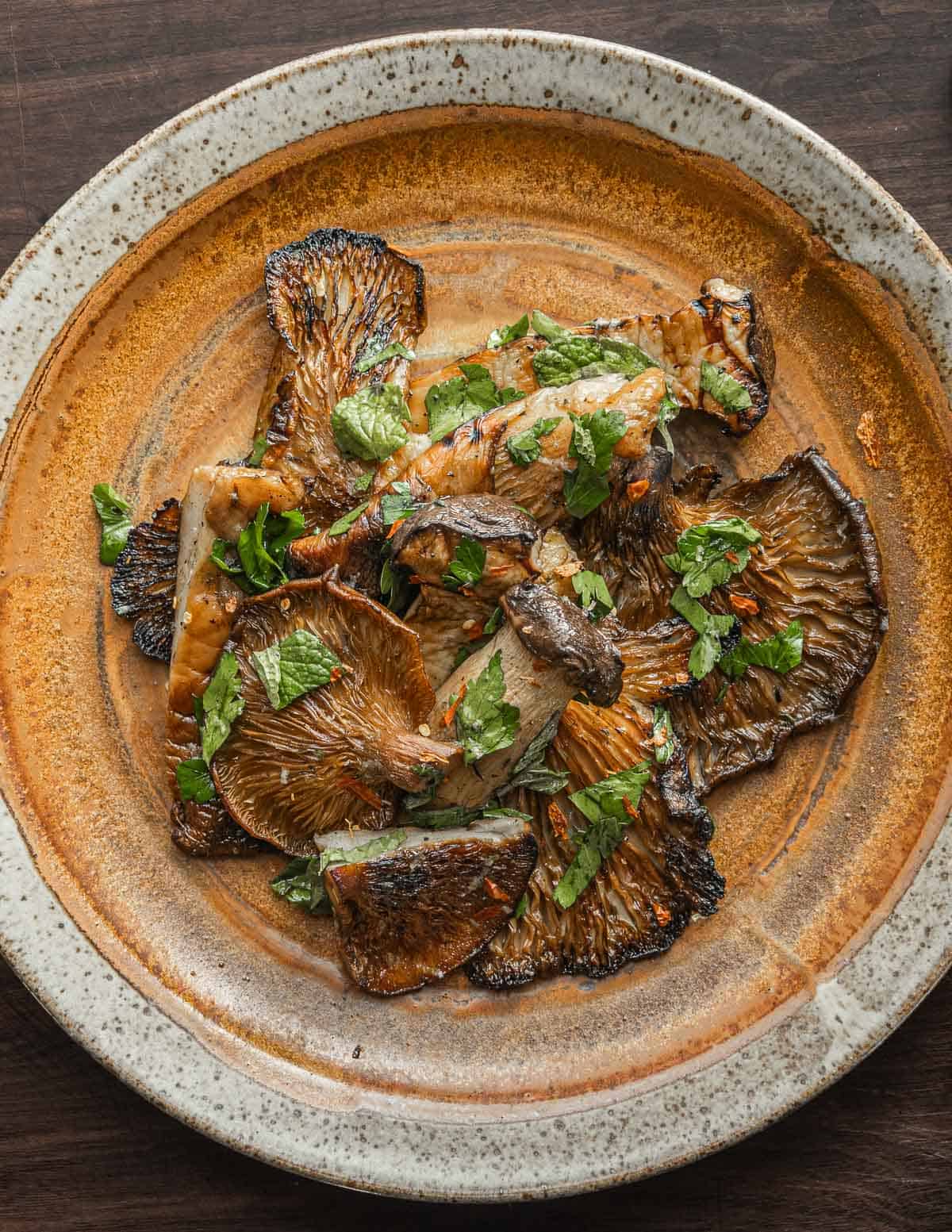 fall oyster mushroom recipe: grilled mukitake with herbs on a plate. 