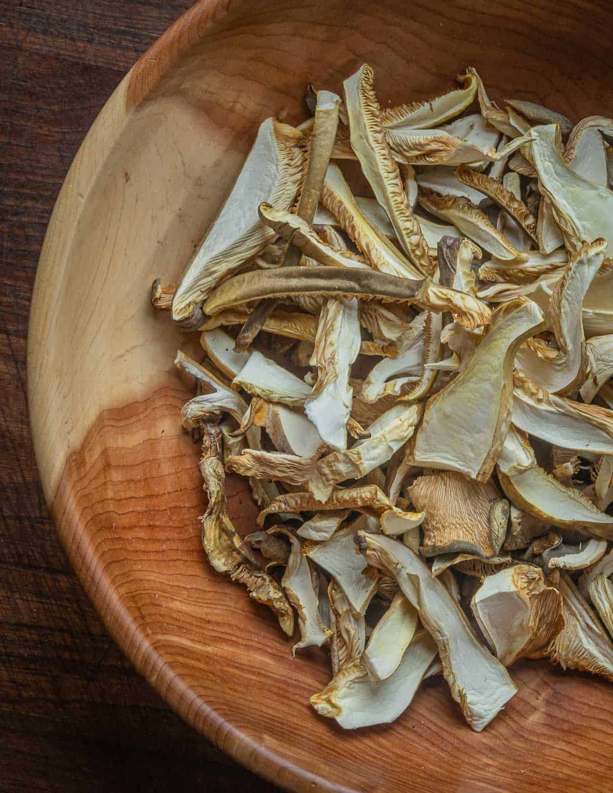 A cedar bowl of dehydrated late fall oyster mushrooms. 