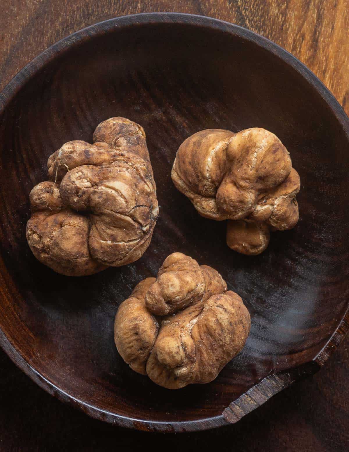 Fresh pecan truffles (Tuber lyonii) in a wooden bowl.