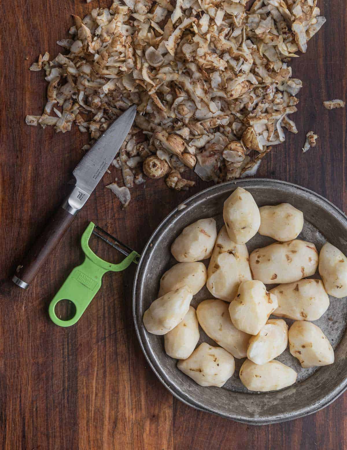 Peeling sunchokes or Jerusalem artichokes using a Kuhn Rikon peeler. 