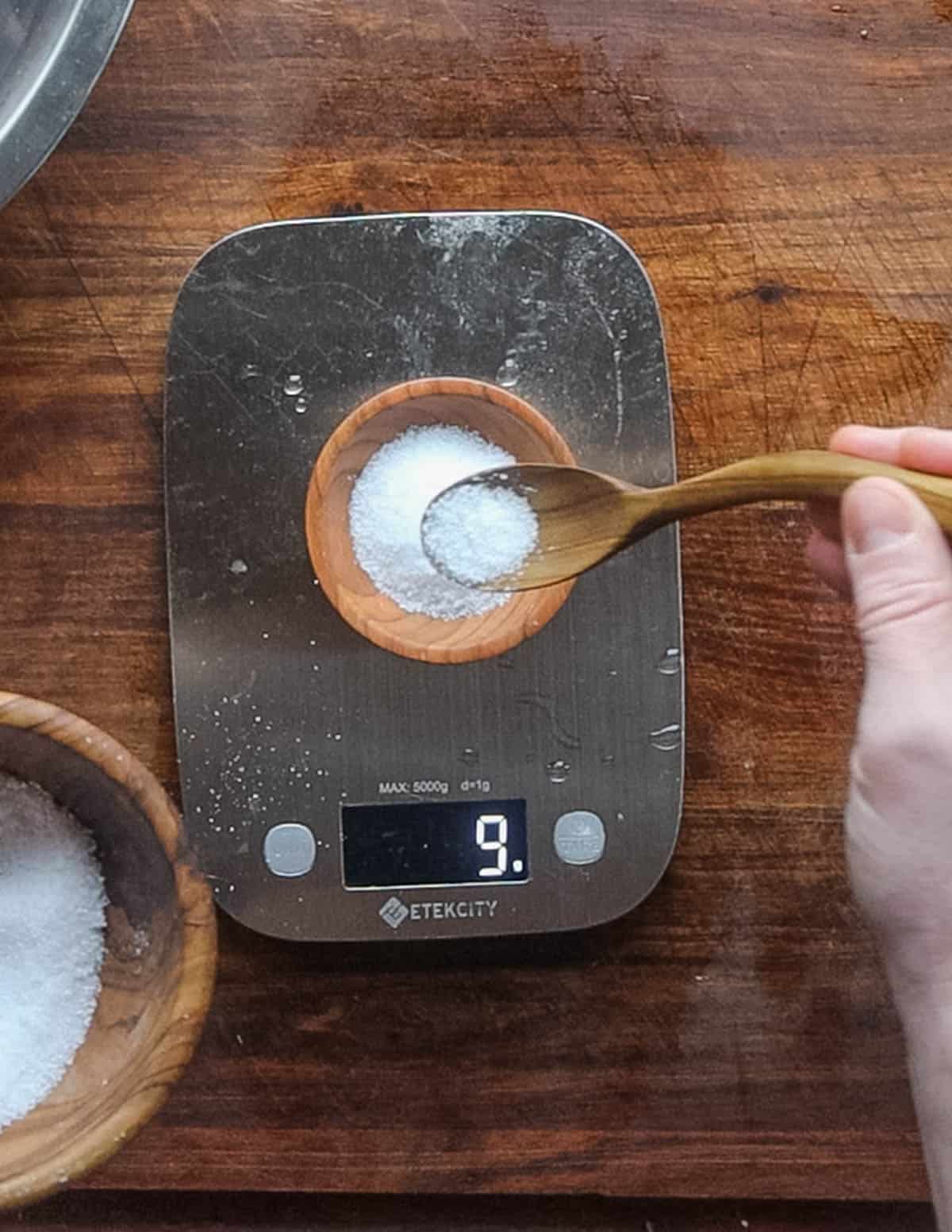 Weighing out salt using a scale. 
