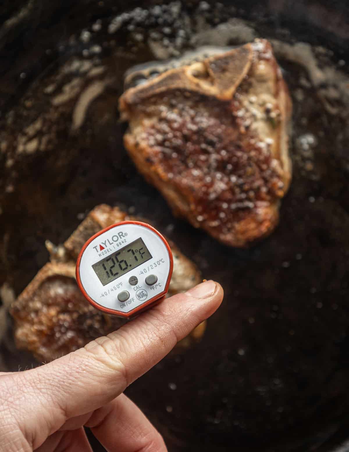 A digital thermometer in a goat chop showing a desired internal temperature. 