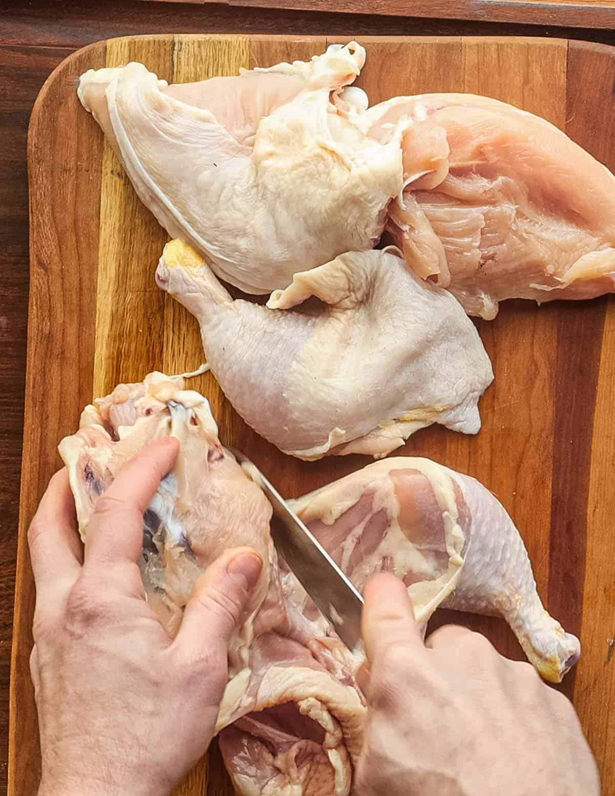 Cutting up a chicken to make chicken broth for ramen. 