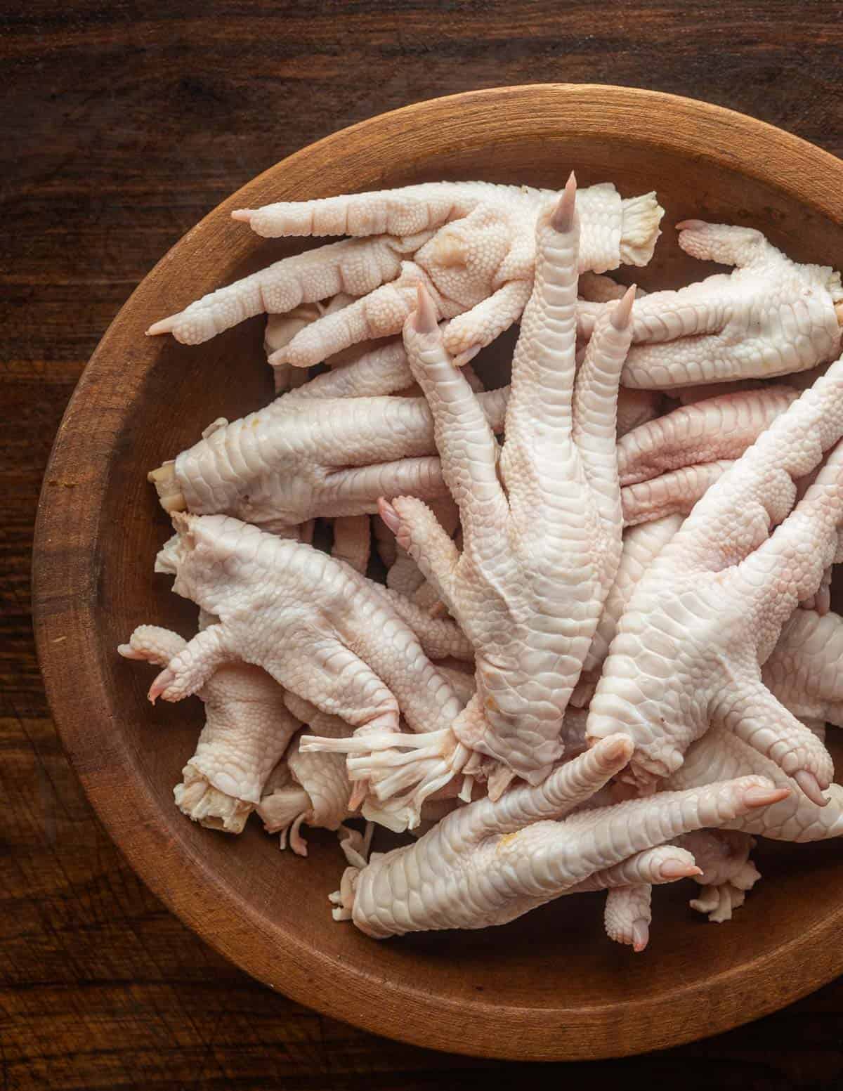 A bowl of raw chicken feet ready to be roasted for soup. 