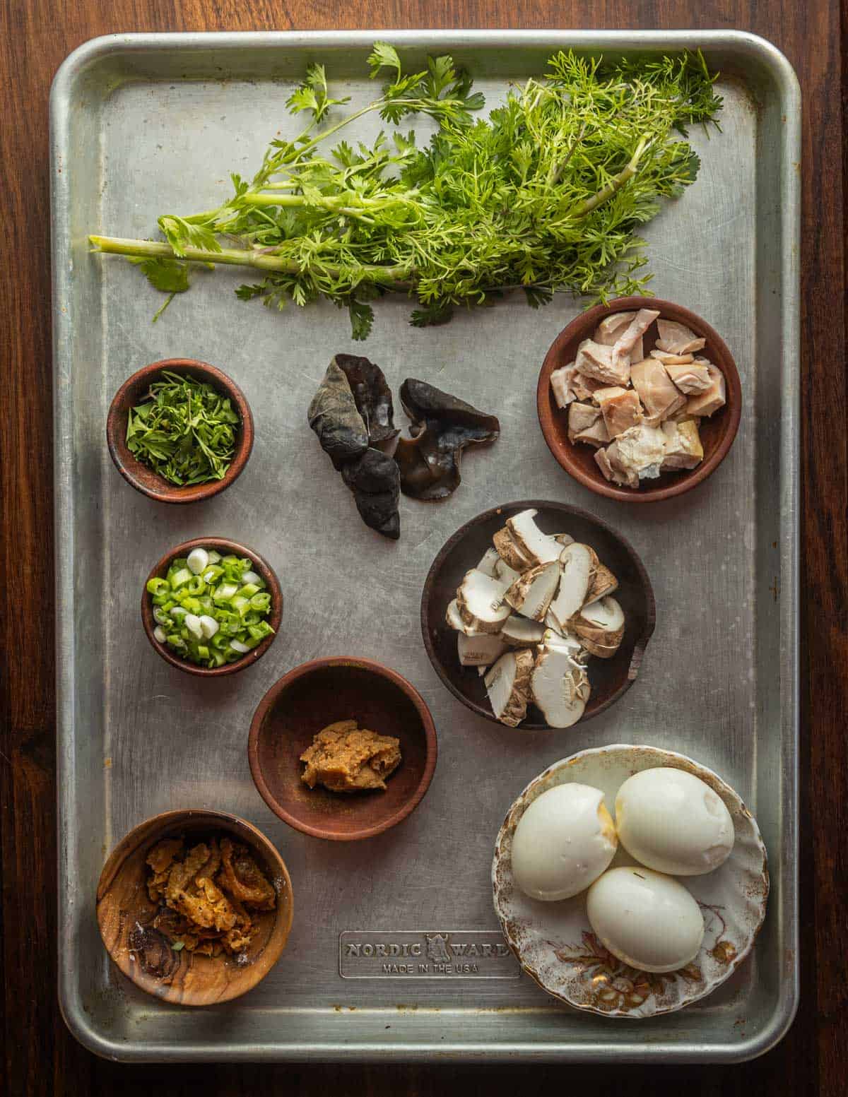 Wood ear ramen ingredients: cilantro, soft eggs, miso, chicken skin, mushrooms, chicken, scallions.
