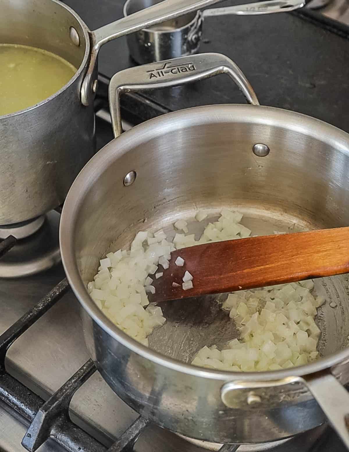 Cooking diced onion in butter to make risotto. 