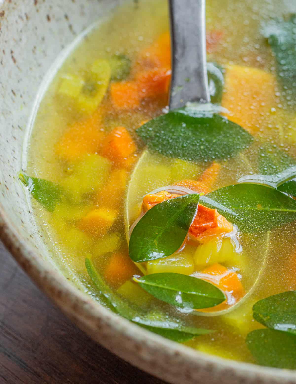 A spoonful of caldo de chipilin con pollo or chicken soup with chipilin leaves. 