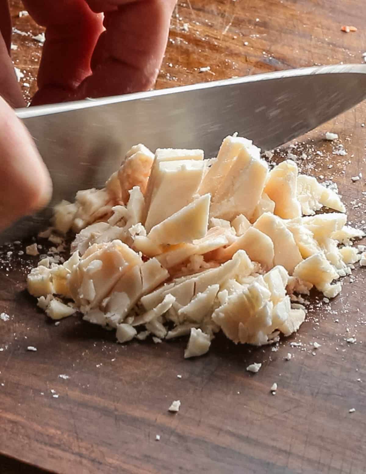 Cutting suet beef into small pieces for rendering tallow. 